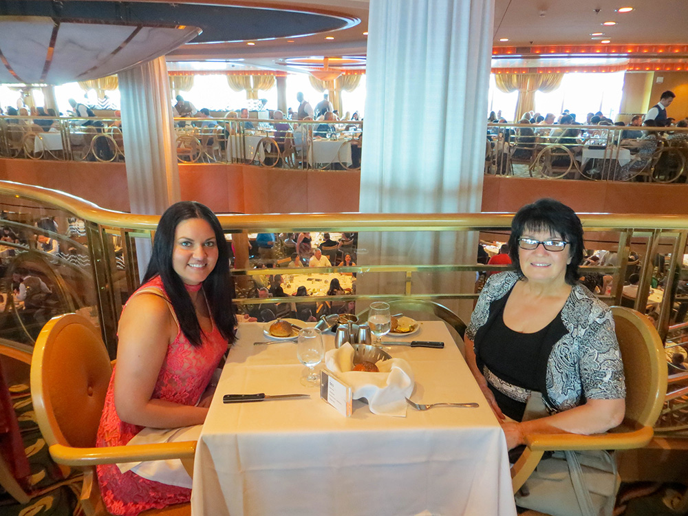 Kadi and her mom having dinner on Royal Caribbean Jewel of the Seas in the main dining room on a formal night 