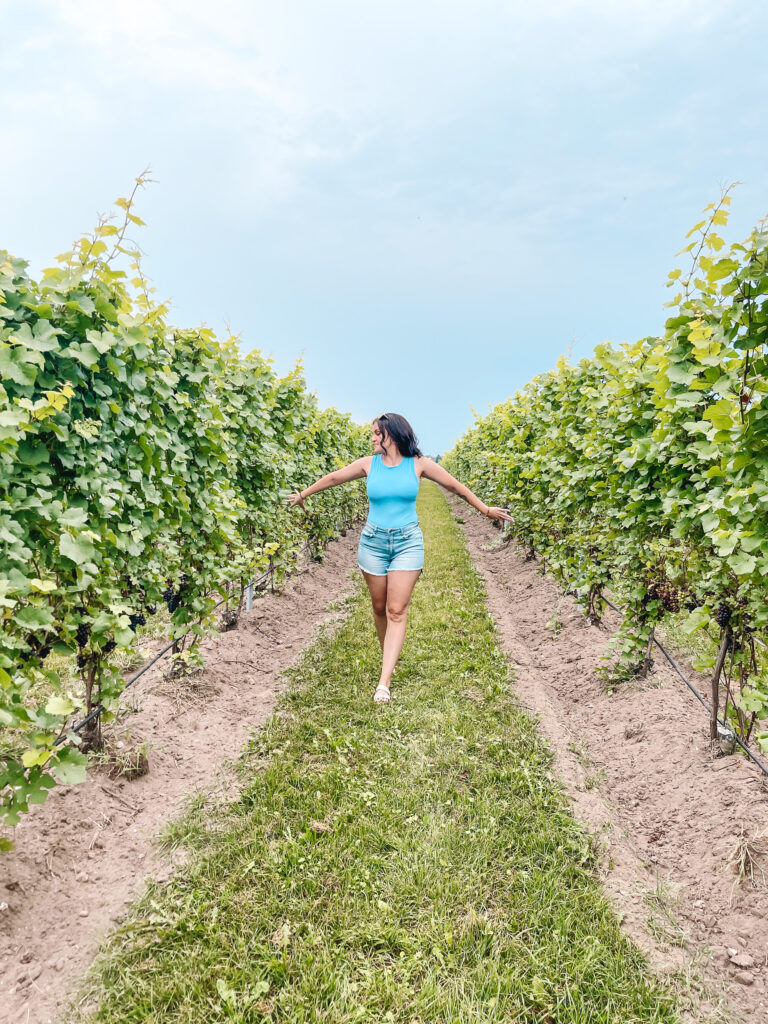 woman walking through a vineyard