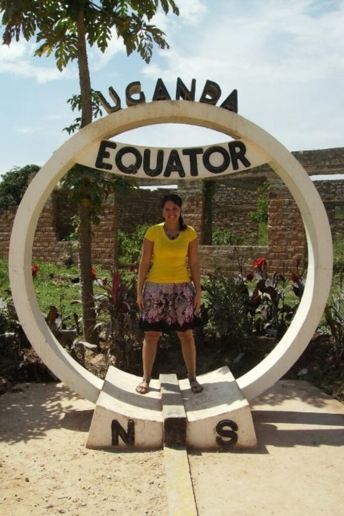 a popular tourist attraction in Uganda Africa is standing at the equator