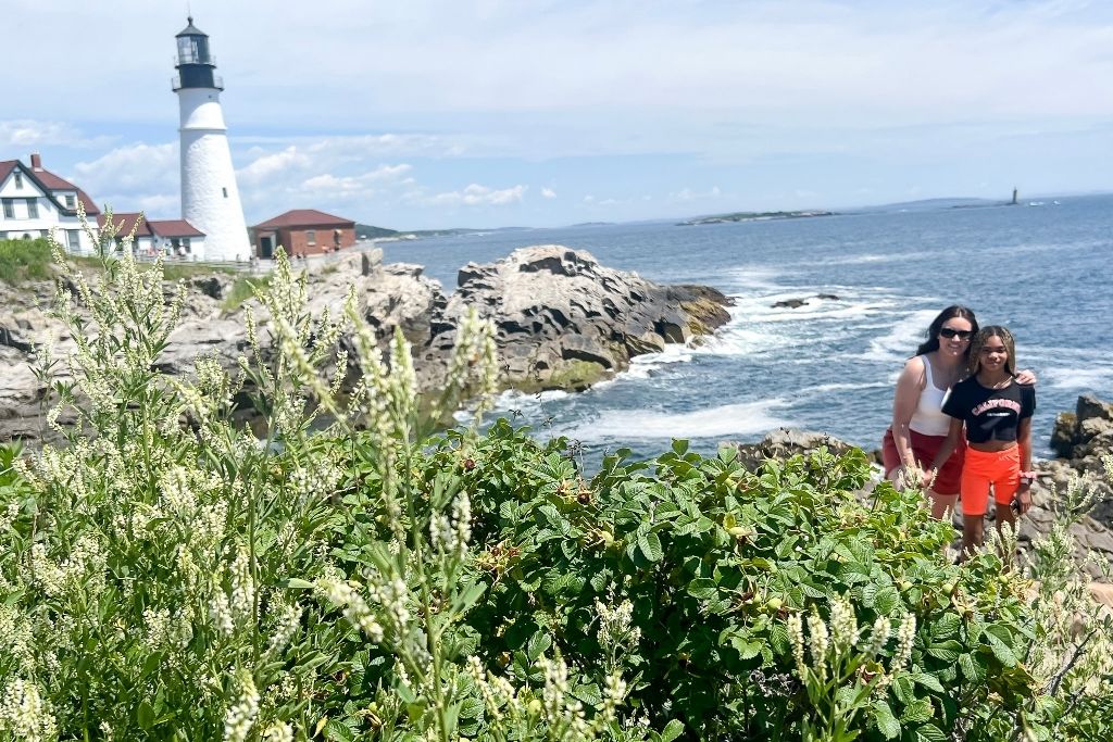 mother and daughter with Portland Headlight in the background